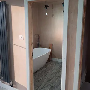 a bathroom with a tub and a radiator in it