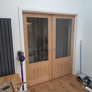 a room with a hard wood floor and two doors