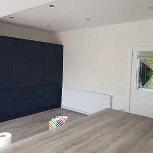an empty room with a table and toilet paper