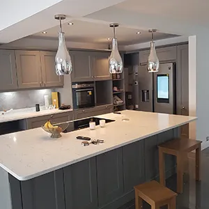 a large kitchen with a center island and two stools