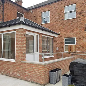 a brick building with a white door and windows