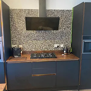 a kitchen with a stove top oven next to a refrigerator
