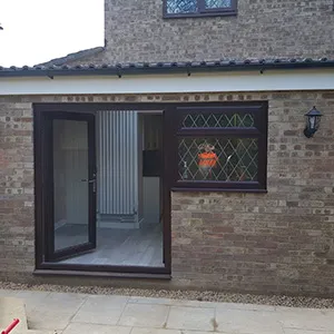 a brick building with a glass door and a brick wall