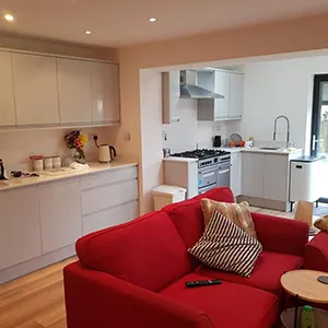 a living room filled with furniture and a kitchen
