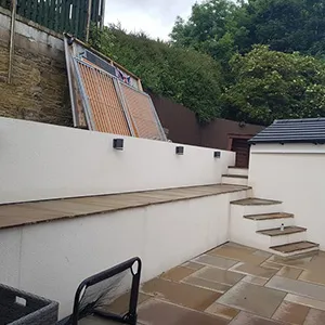 a back yard with steps leading up to a house